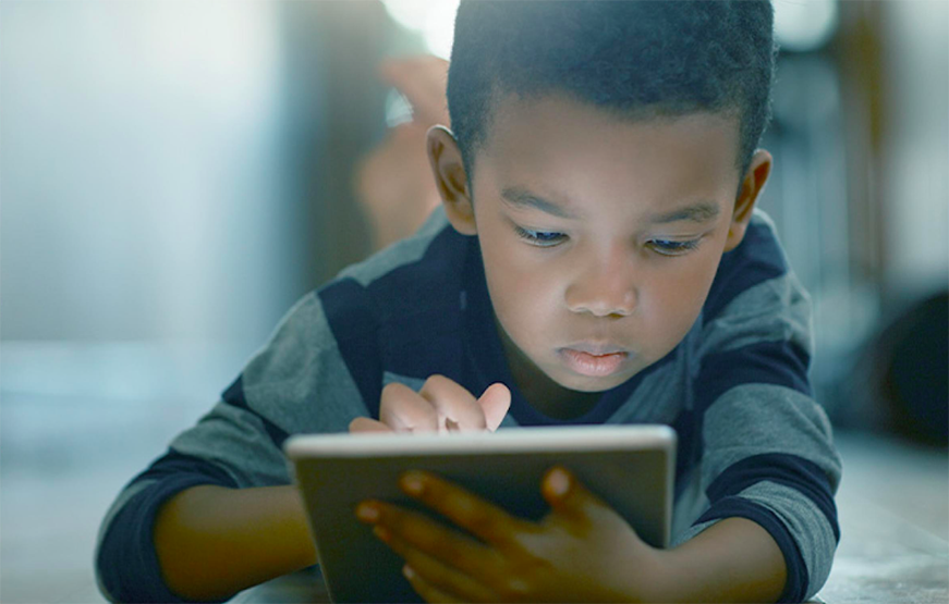 child playing on tablet device
