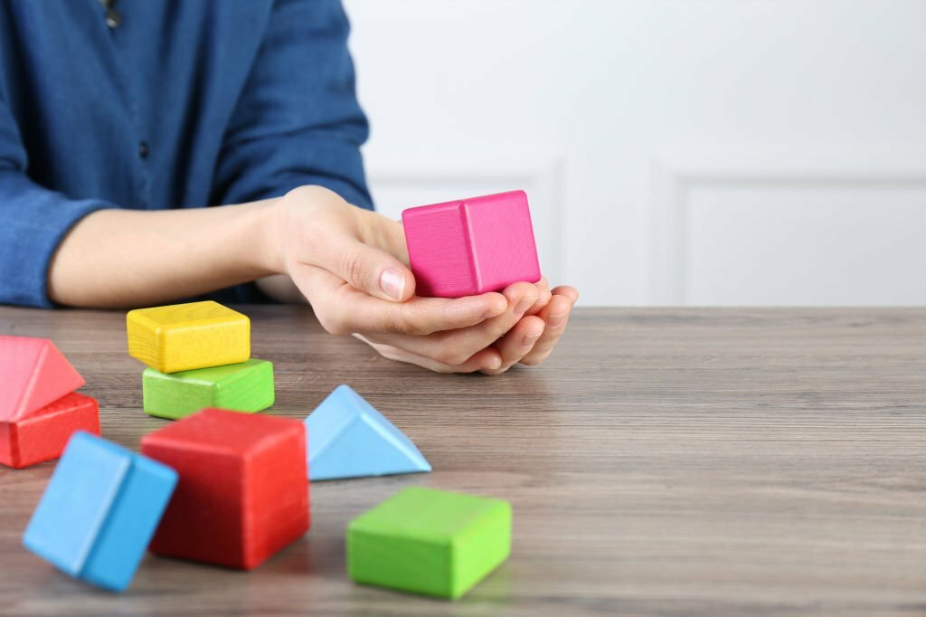 ABA therapist with colorful building blocks